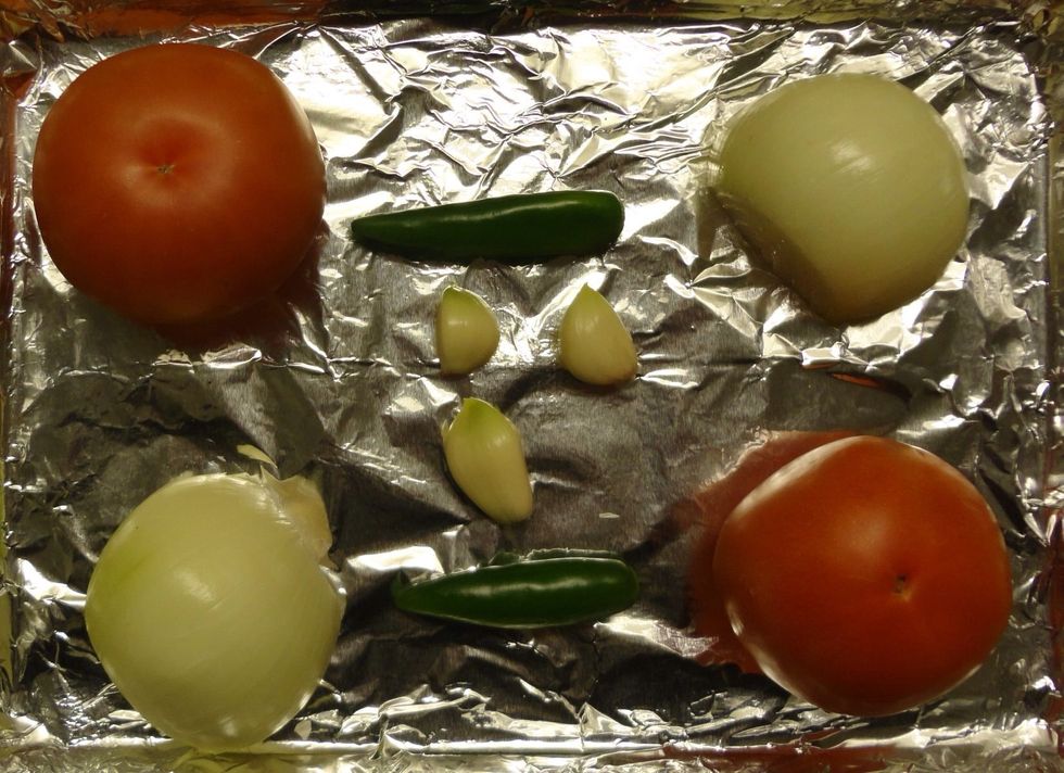 Cover a cookie sheet with foil and place the ingredients on it. For this guide, we will use a gas oven. Set it to broil and put the ingredients 6-10 inches from the flame. We want a tasty char!