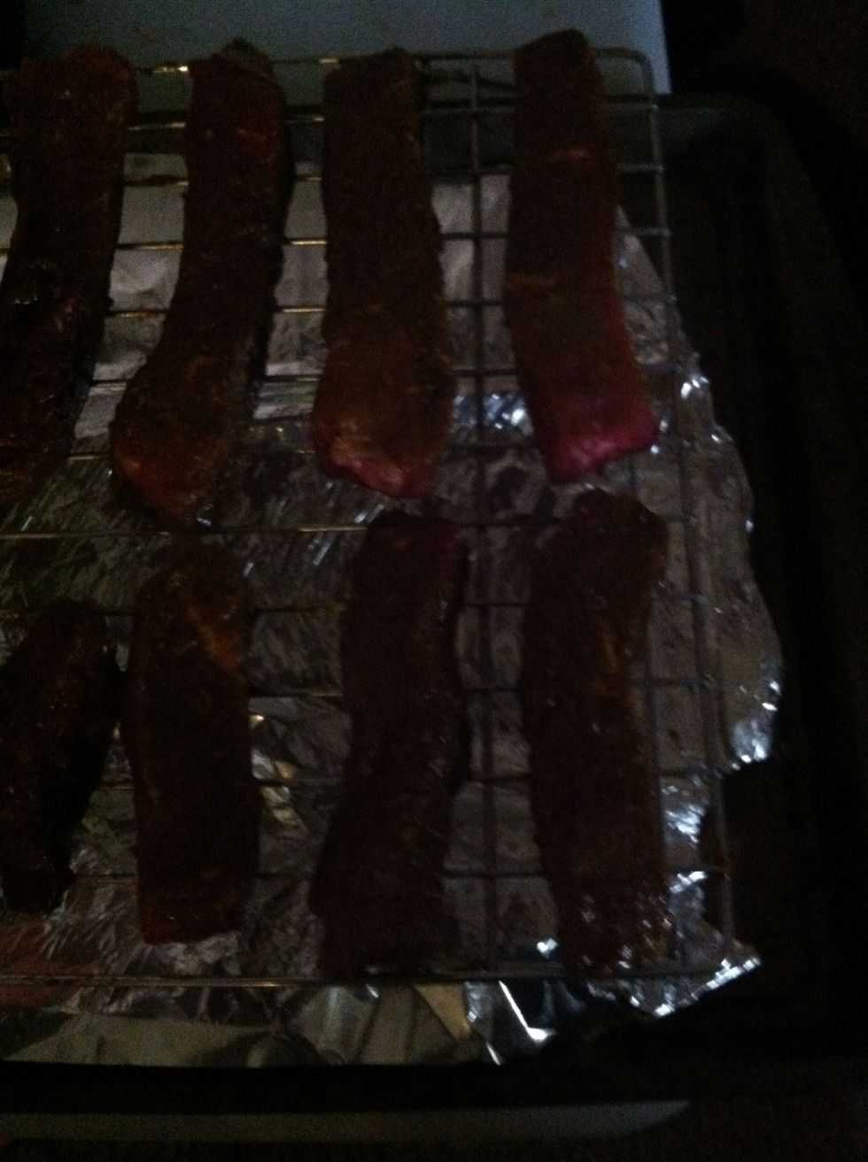 Cover a cookie sheet with tin foil before standing rack on it. Place the meat strips along it as shown.
