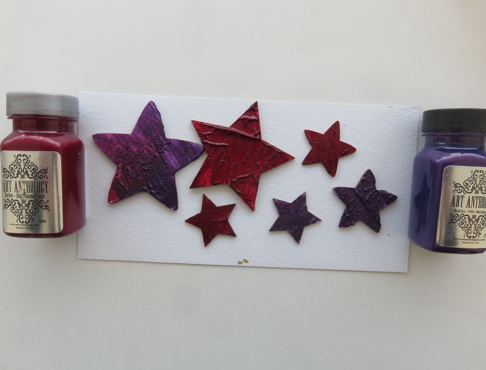 Cover a few different chipboard stars with Mardi Gras Velvet and Red Velvet Sorbet as shown. You can mix those two colors over the same chipboard piece. Let them dry.