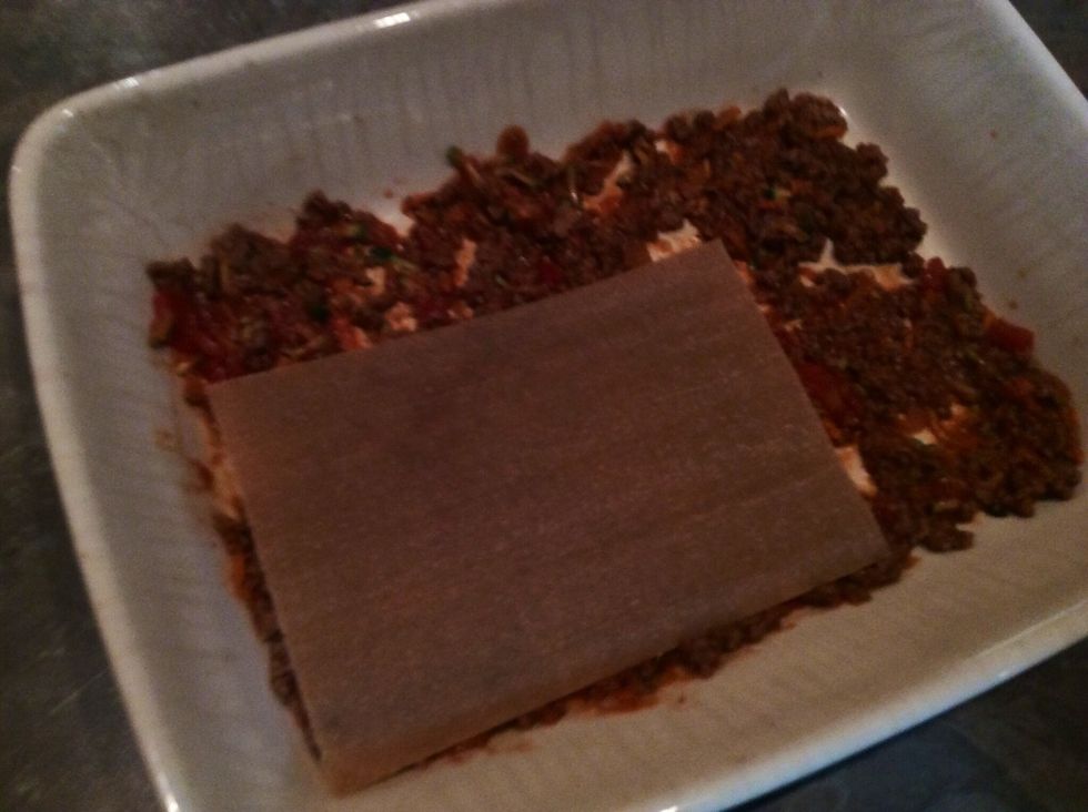 Cover all meat with lasagna sheets.