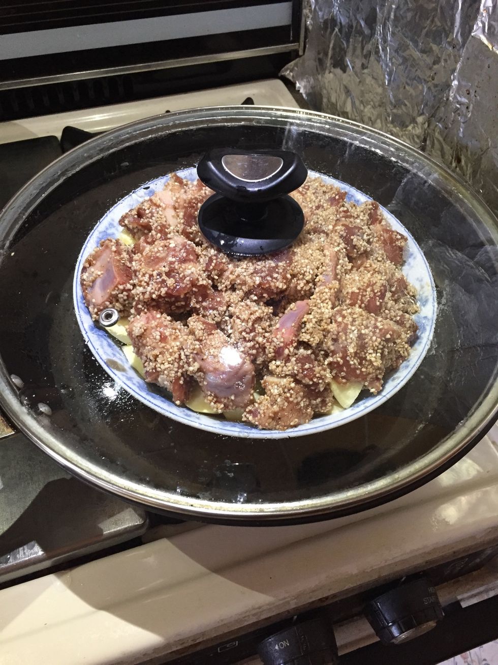 Cover and bring water to a boil. Then reduce to medium heat for water to simmer. Steam for 2 hours.