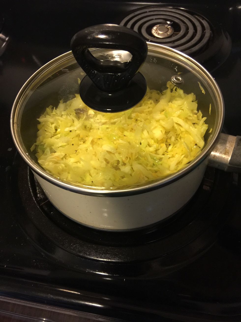 Cover and let it cook for 5 mins. Then open the lid, stir the vegetable and let cook till all water has evaporated and the cabbage is cooked.