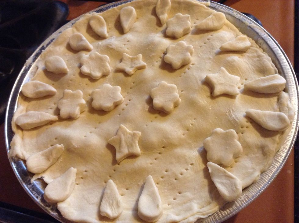 Cover and make small holes with a fork and set the decorations as you wish