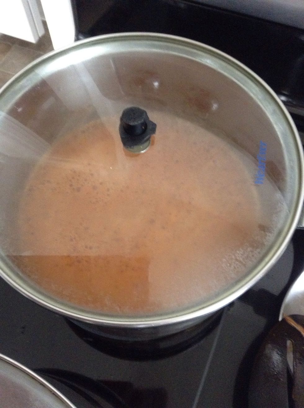 Cover, and place on low heat until water is gone. When water is gone, it will still be a little hard..just turn off the stove and the vapor will cook it the rest of the way.