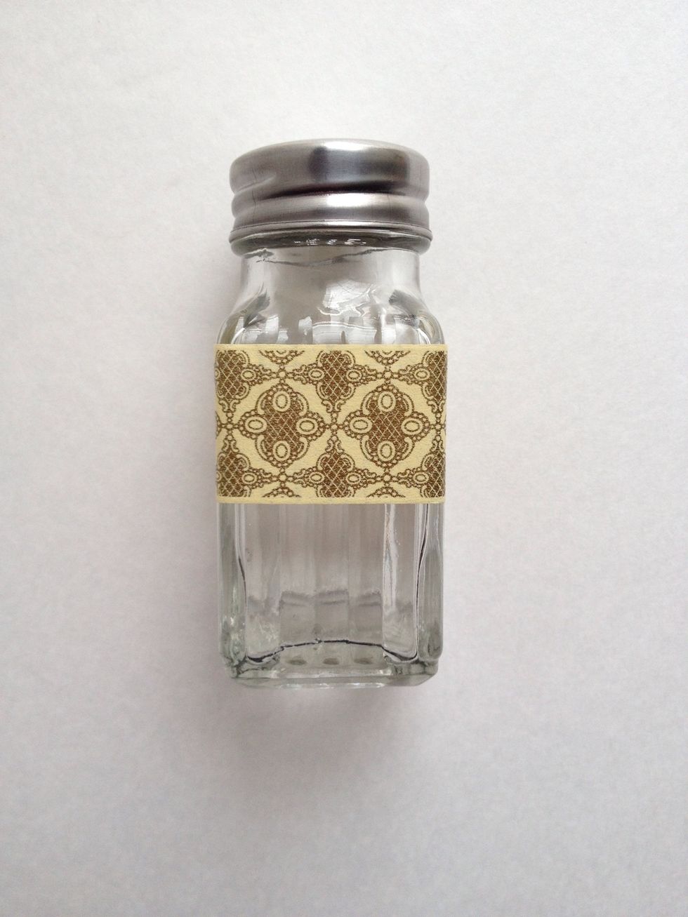 Cover as much of the surface as you can. Start from the top and wrap your washi tape all around your shaker. Trim. If you like, place glue or other adhesive behind the washi tape before attaching.
