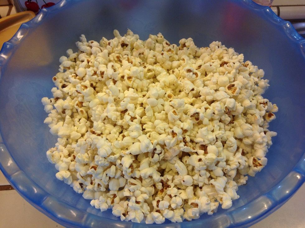 Cover bottom of pan with a thin coat of oil.  Once oil is sizzling, add popcorn kernels to fill bottom of pan.  Pour popped kernels in large bowl, remove any unpopped kernels.