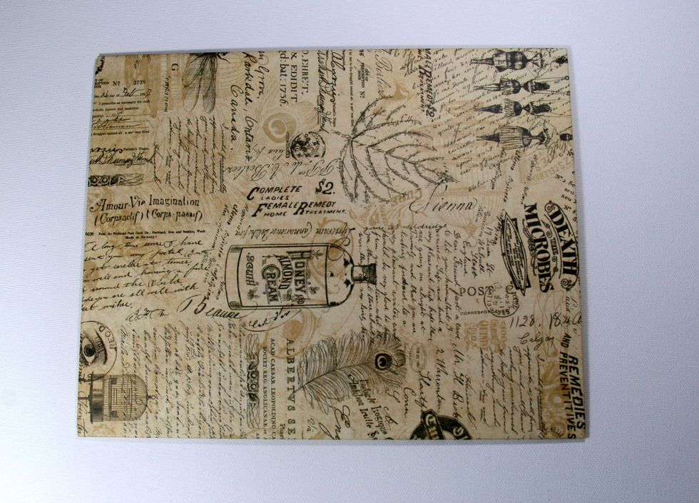 Cover chipboard panel with DIY Craft Paper-Curiosity Collage & Butterflies. Make sure to wrap around and secure in back to have nice finished edges. Coat with Mod Podge and allow to dry.