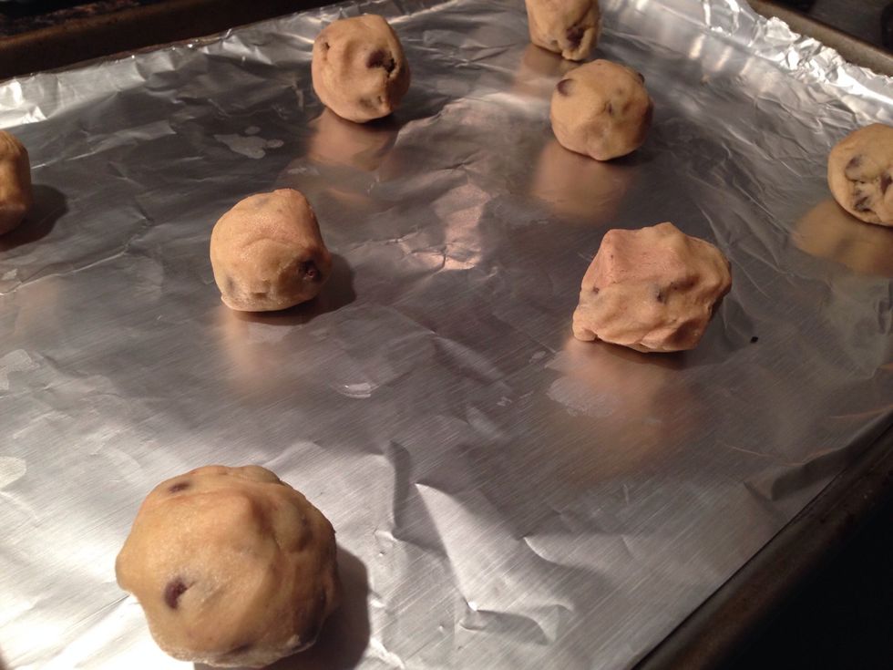Cover cookie sheet with non-stick aluminum foil. Add a spoonful or so of dough (depending on your desired cookie consumption) about three inches apart. Bake at 375\u00b0F for 8-10 minutes.