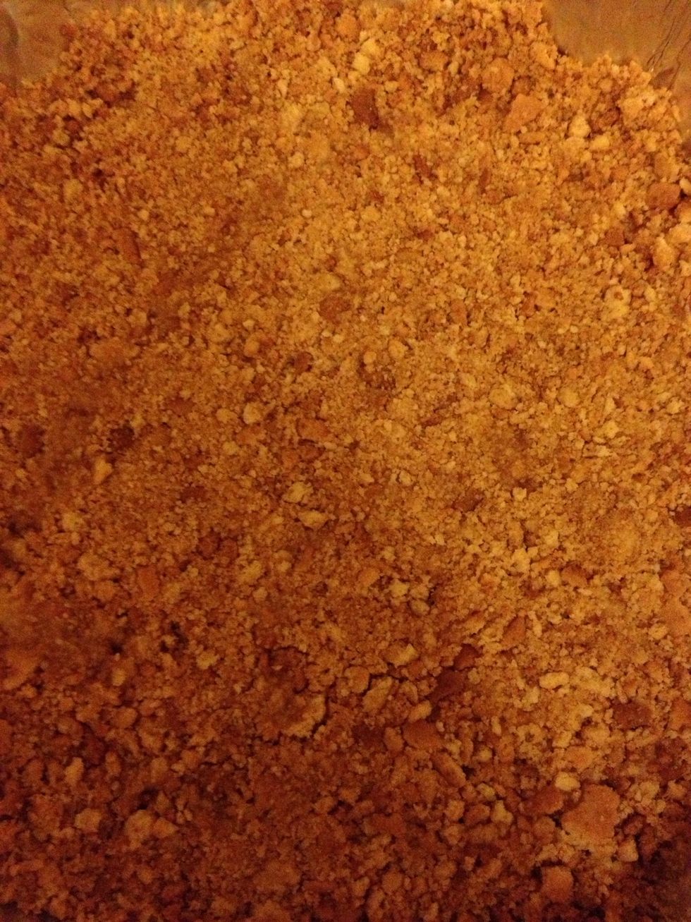 Cover crumbs all over tray to make sure it's enough then pour butter over the crumbs and mix well with your hands then form a pie crust. Refrigerate for 1 hour