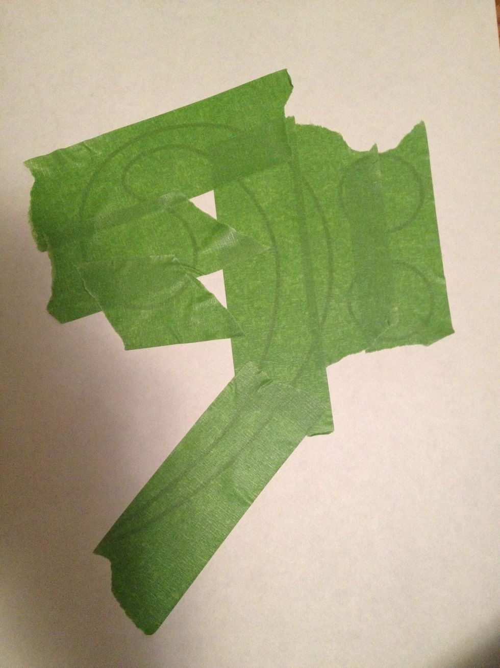 Cover design in painters tape. Do NOT push down to hard if using regular paper. You want to be able to pull it up soon. Using as few pieces of tape as possible leads to better results.