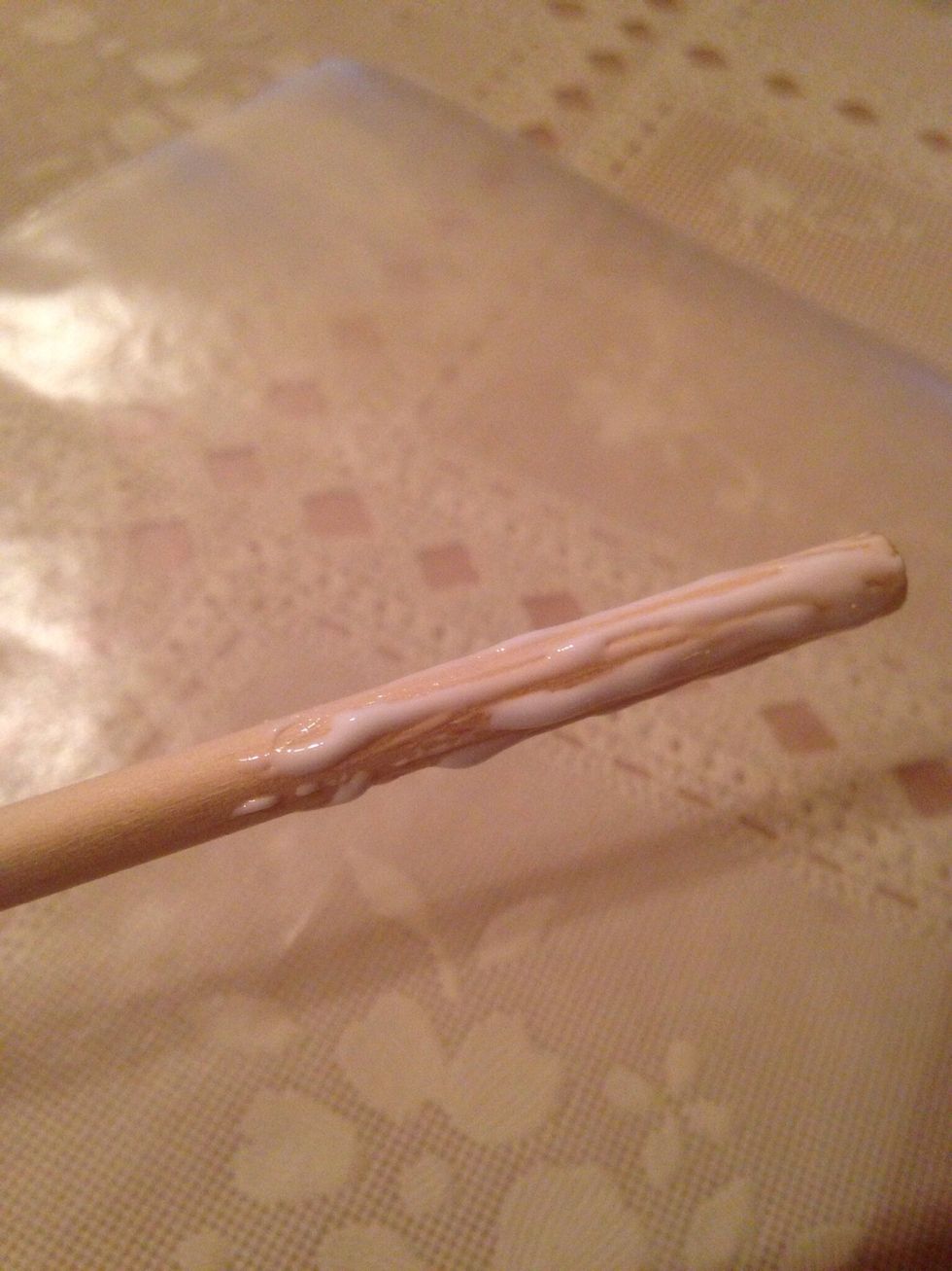 Cover end of dowel with tacky glue. Spread on all sides. It is a thicker glue, so it will not drip. Start off with about three to four inches.