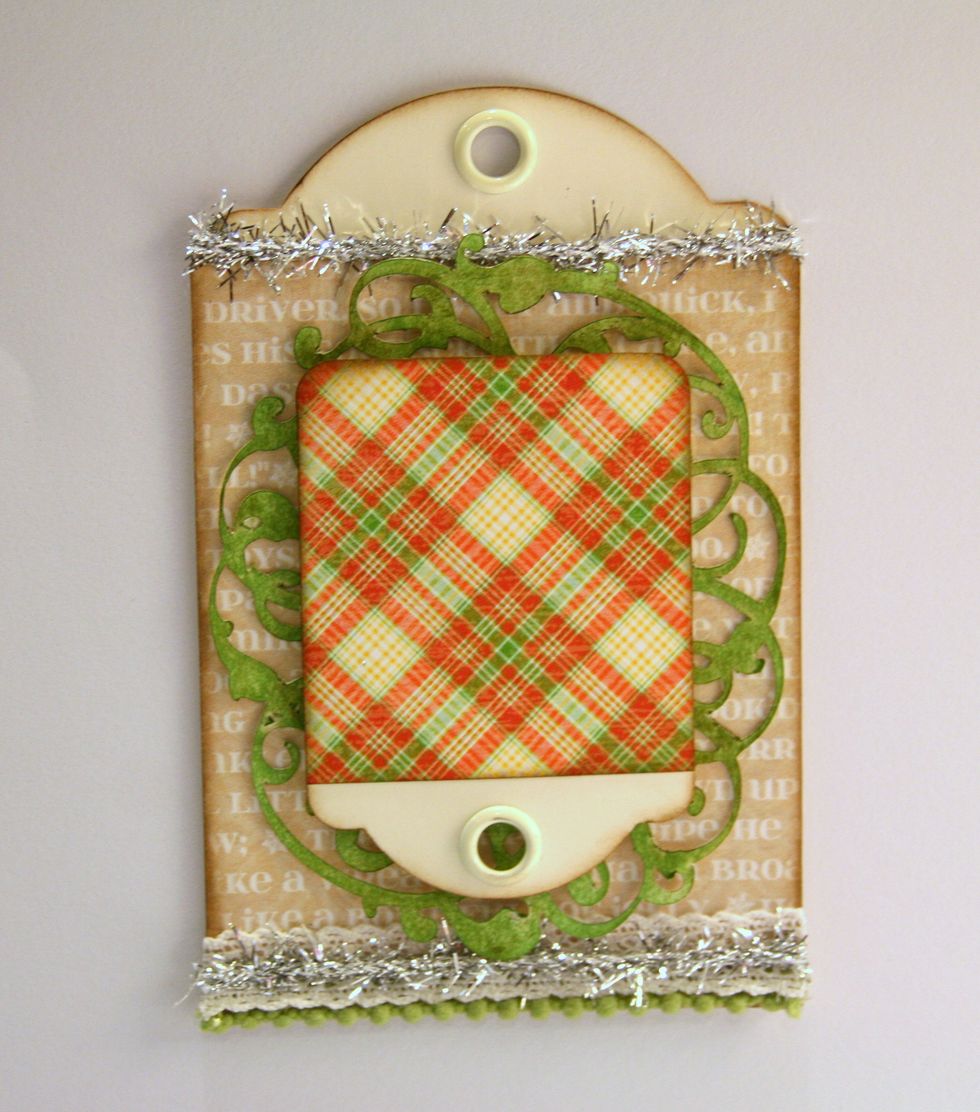 Cover frame with a well inked patterned paper covered Trading Tag. Use foam spacers for dimension.