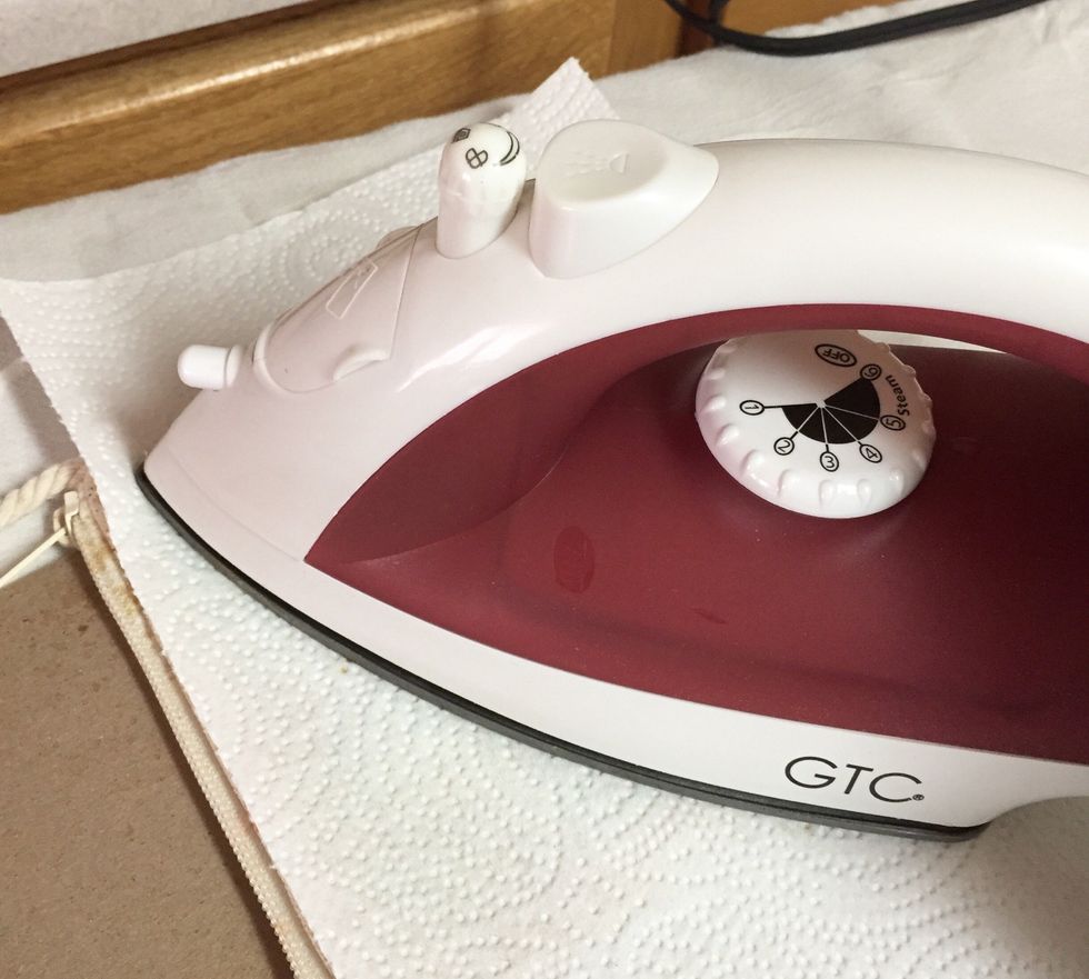 cover ironing board with a rag and then cover bag with clean paper towels. iron over design to heat set inks, moving iron around every few seconds.