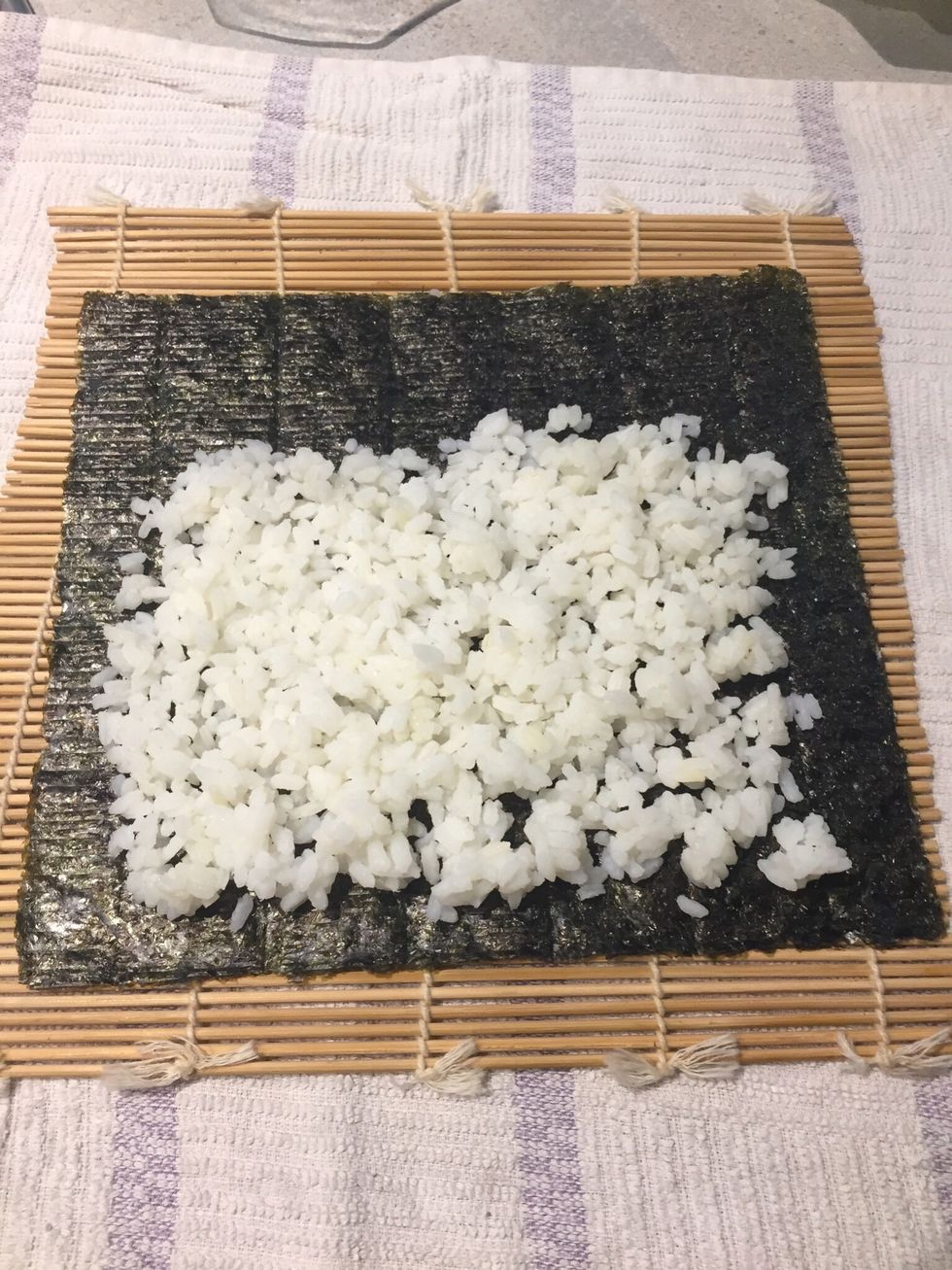 Cover it as thinly as you can with the Rice mixture (about 1cm of Rice). Leave about 1/4 to 1/3 of the nori uncovered at the top, this will be used to seal the nori when it is rolled up.