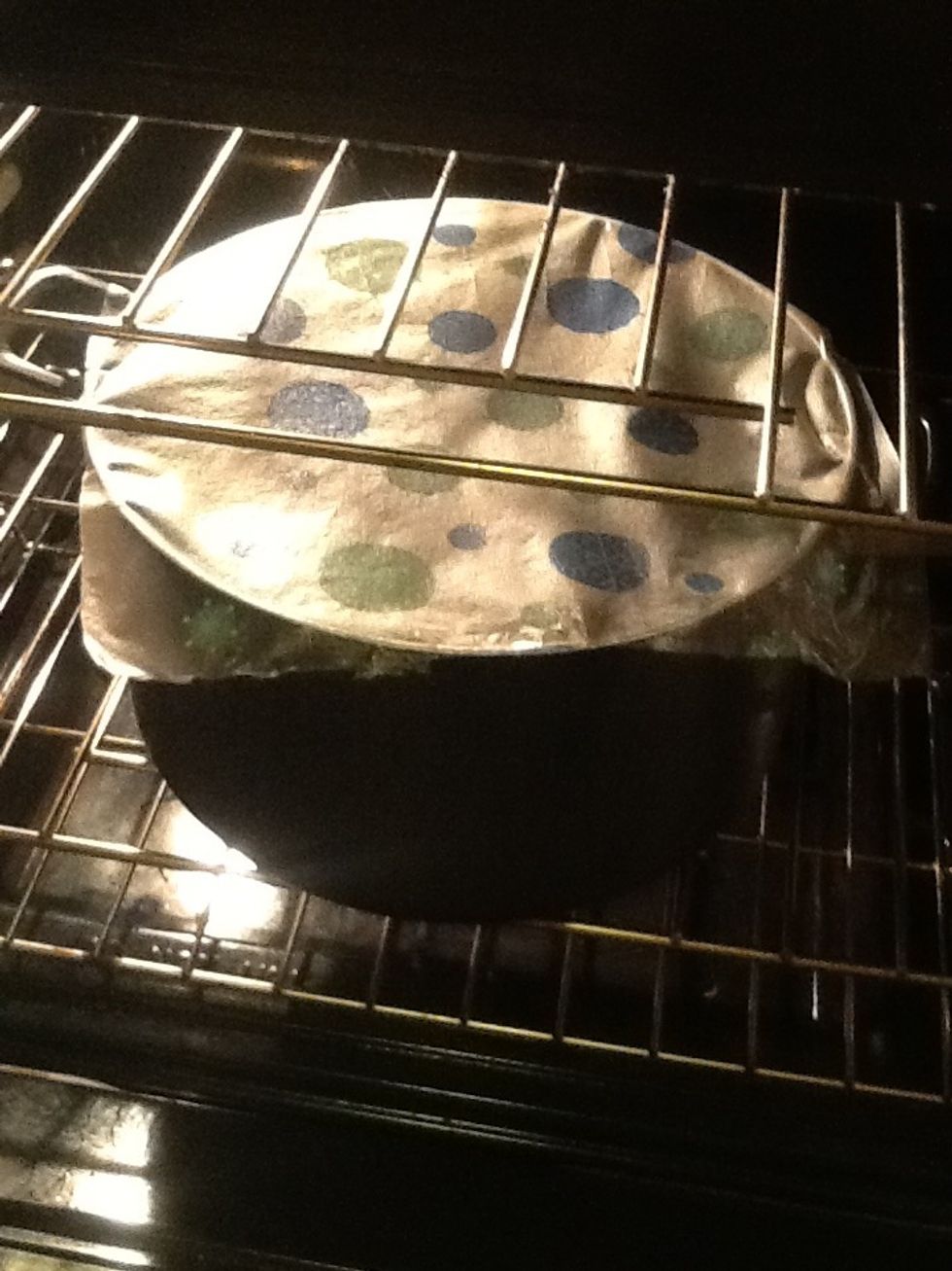 Cover it with saran wrap. Put it in a warm place so it can rise. I put it in my oven with the light on. Let it rise for 90 minutes.