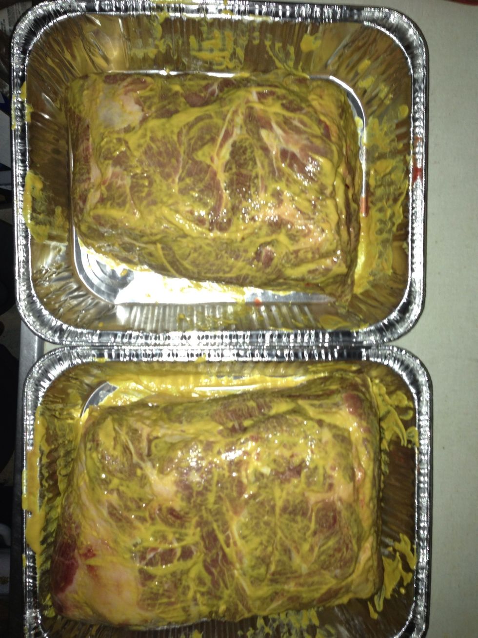 Cover Meat with yellow mustard. This will provide some flavor but it is mainly to provide a base coat for the rub.