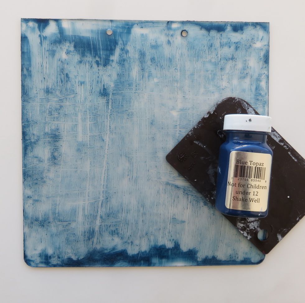 Cover one side of 20*20'' clear acrylic album page with a thin layer of Art Anthology Blue Topaz paint. Use the painters comb to spread the paint over the whole piece.