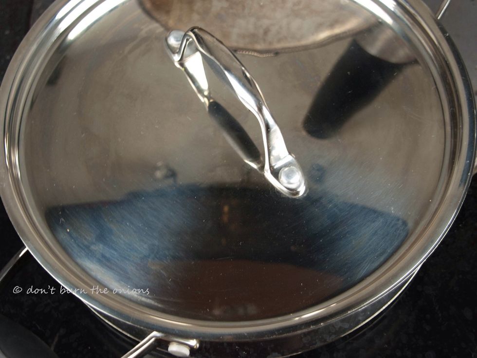 Cover pan completely to enable  clams to steam in their own juices.