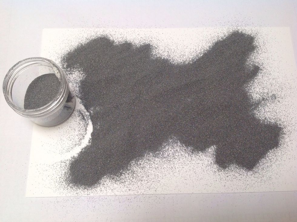 Cover stamped image with embossing powder --- once done, remove the excess powder and place back in the container
