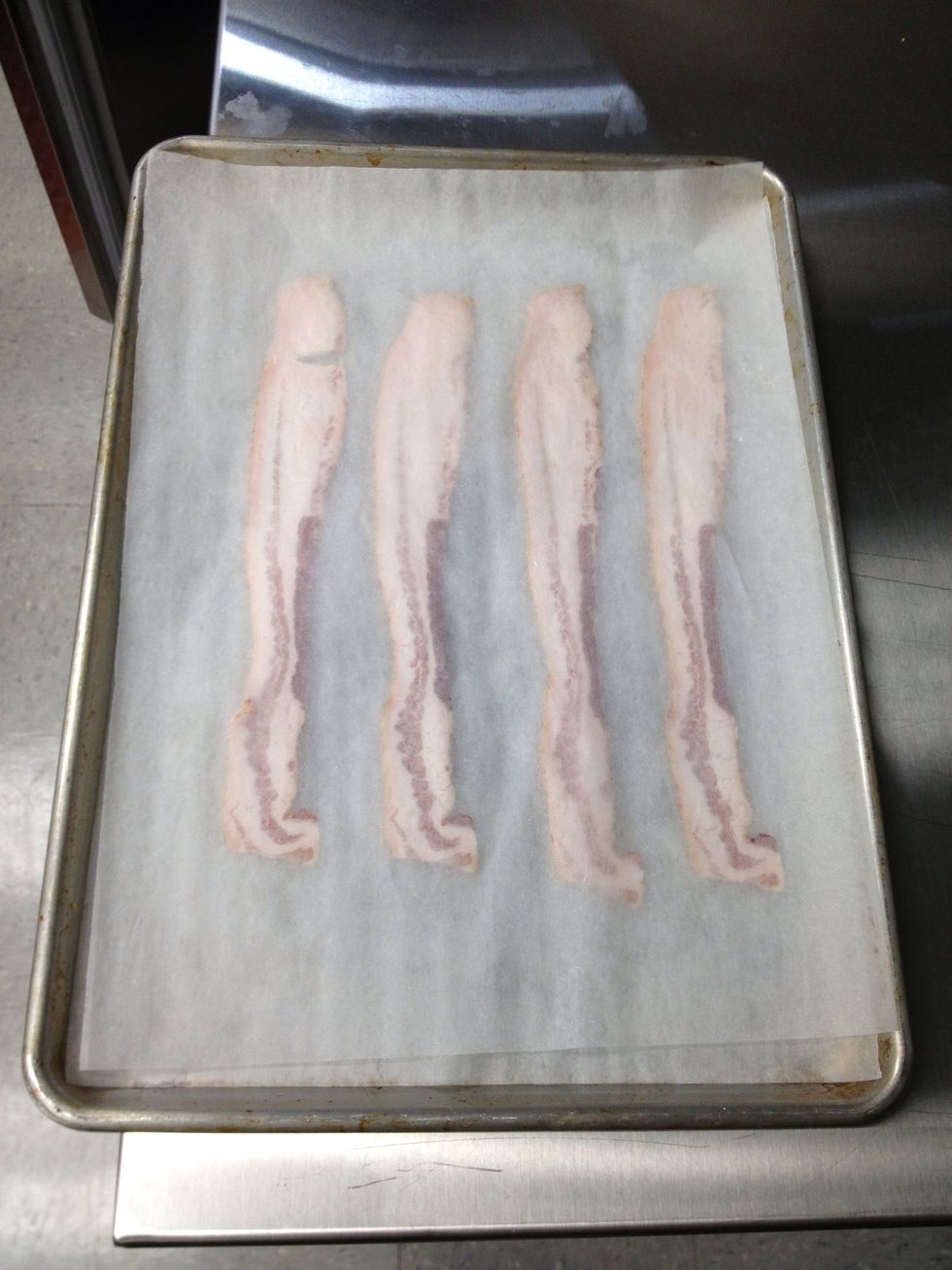 Cover the bacon with parchment paper.