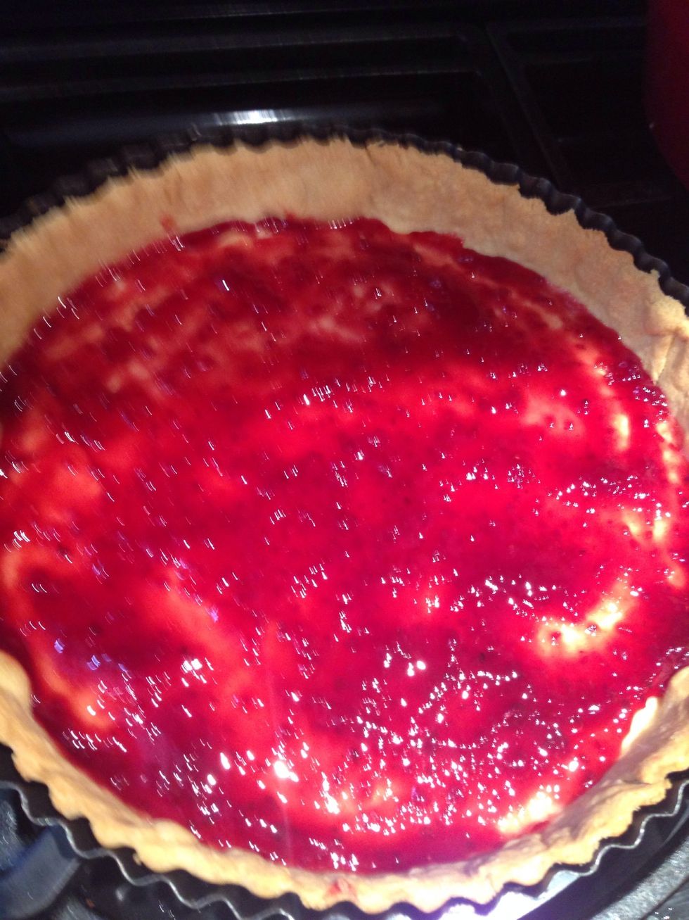 Cover the base of the tart with raspberry jam