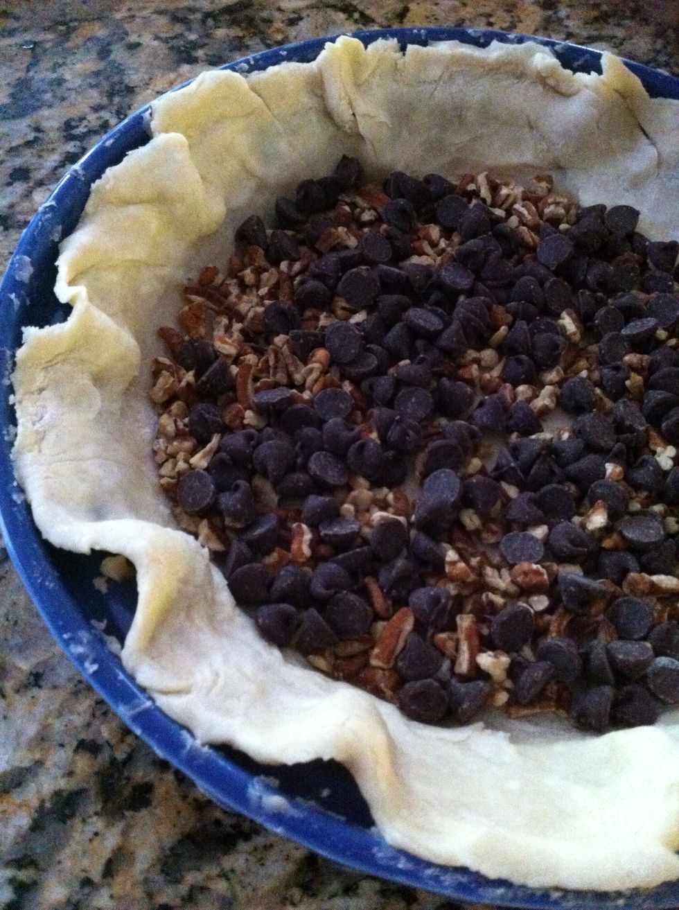 Cover the bottom of pie shell with 1/2 cup pecans and as many choc chips as you want.  I use semi sweet