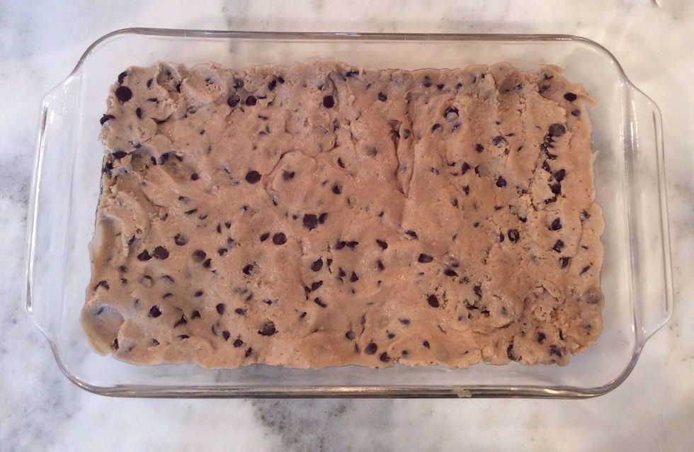Cover the bottom of the pan with cookie dough. Make sure the whole pan is covered and the cookie dough is evenly spread out.