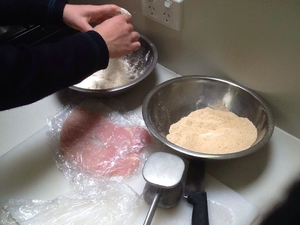 Cover the chicken breast in flour then dip it in the whisked egg and milk mixture. Then cover the chicken in breadcrumbs