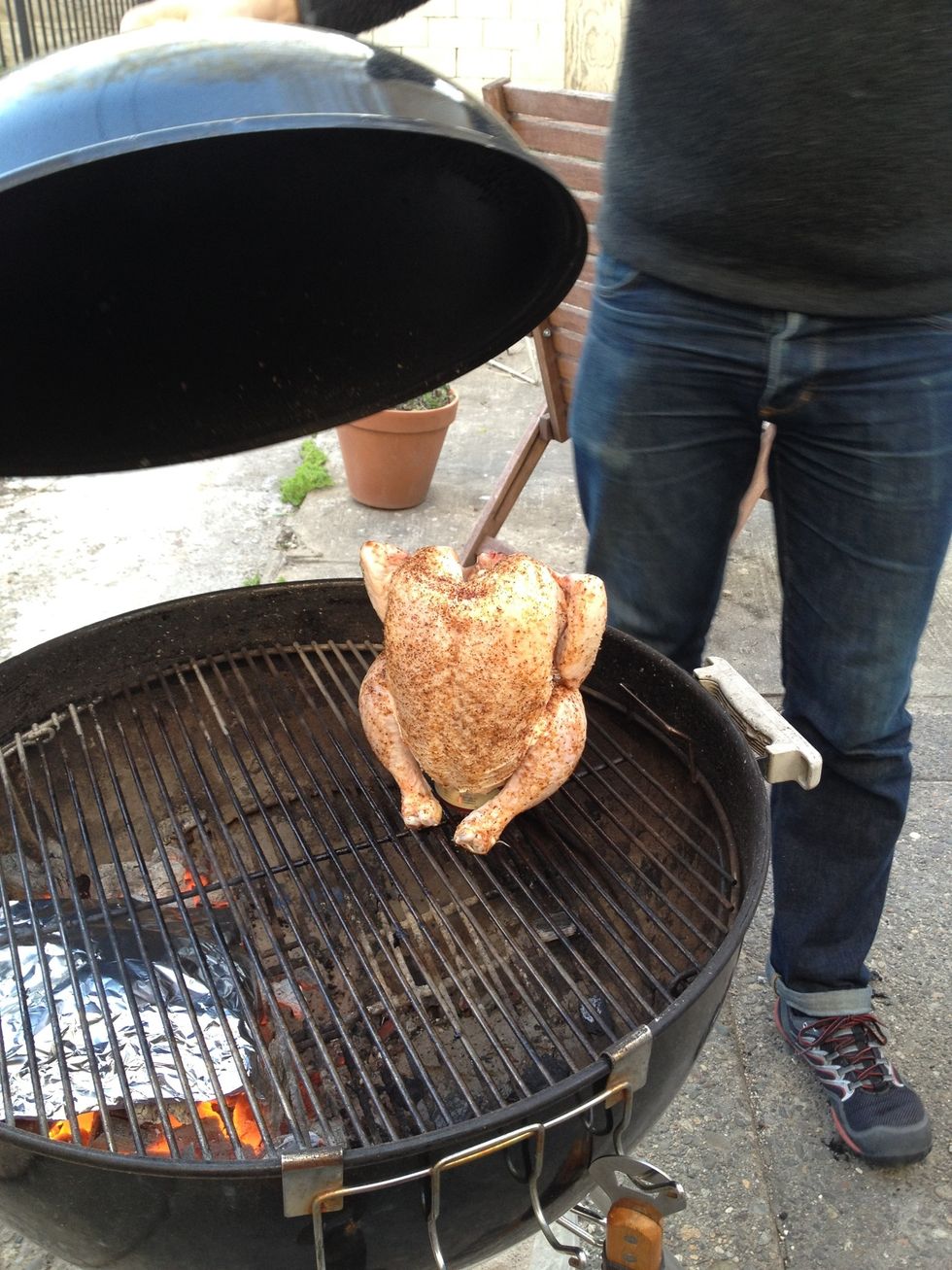 Cover the chicken. If the grill top is touching the bird you can tent it with foil. Set your vents to almost closed to keep the heat relatively low, or set your fancy gas grill to medium low.