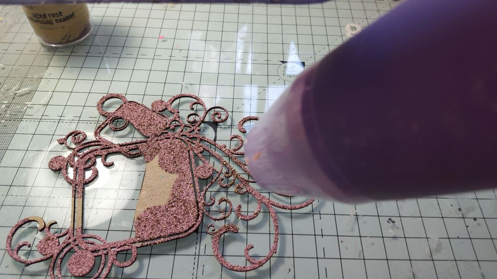 Cover the chipboard flourish with embossing powder. I didn't cover all mine as some of it was going to be covered and I didn't want to waste any embossing powder!