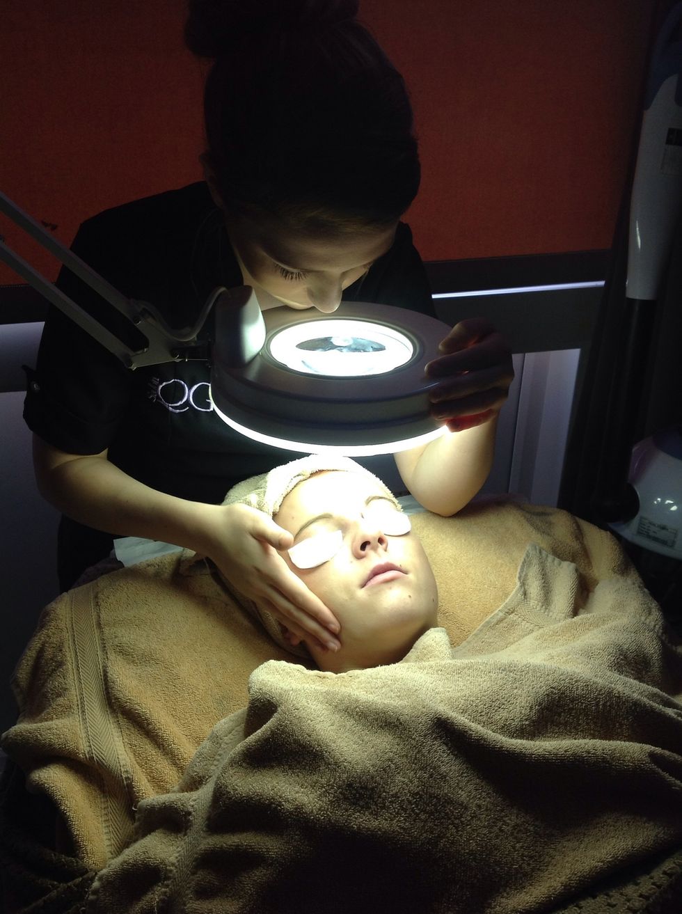 Cover the clients eyes with damp cotton wool pads and using the magnify lamp identify skin types and conditions. Discuss clients concerns and devise a treatment plan.