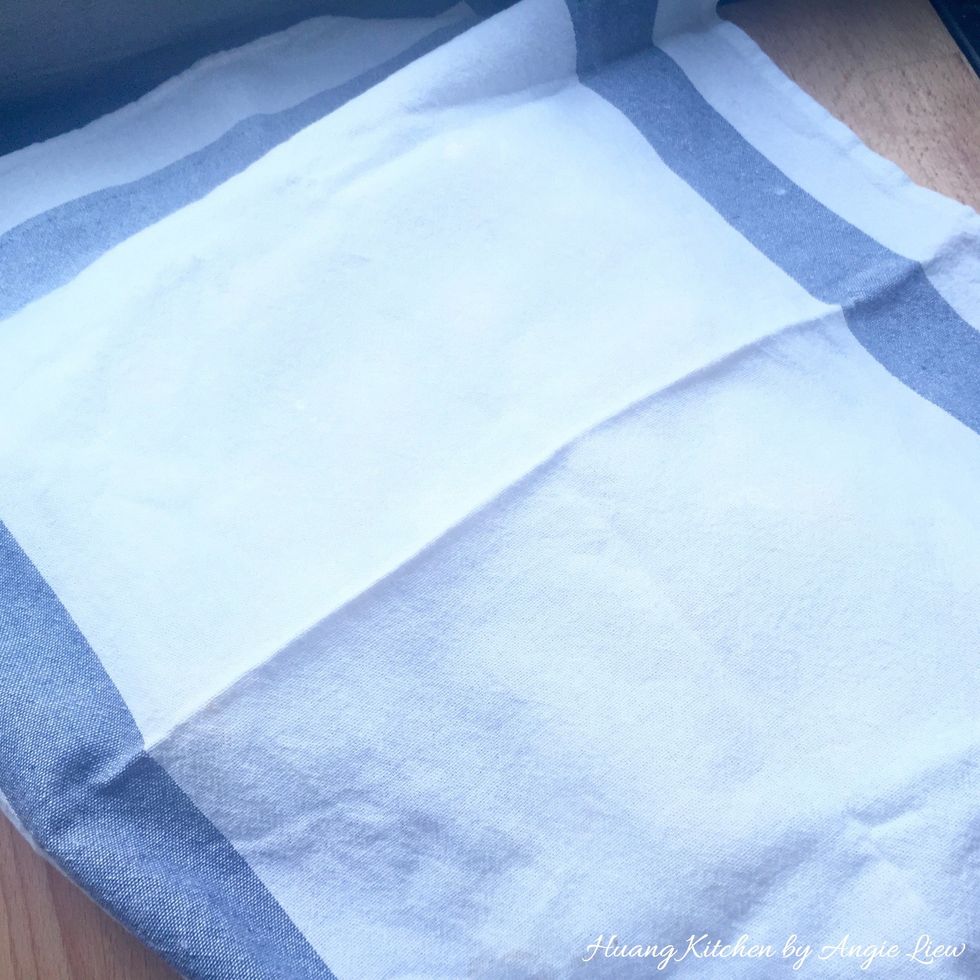 Cover the combined WATER and OIL dough with a damp cloth to prevent the dough from drying out.