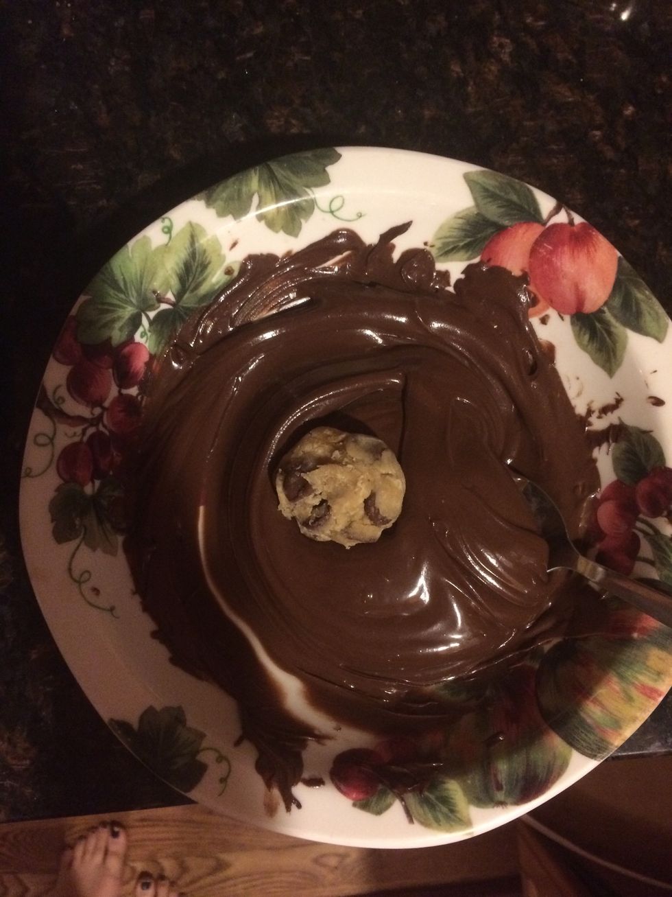 Cover the cookies with the melted chocolate. Tap off any excess chocolate.