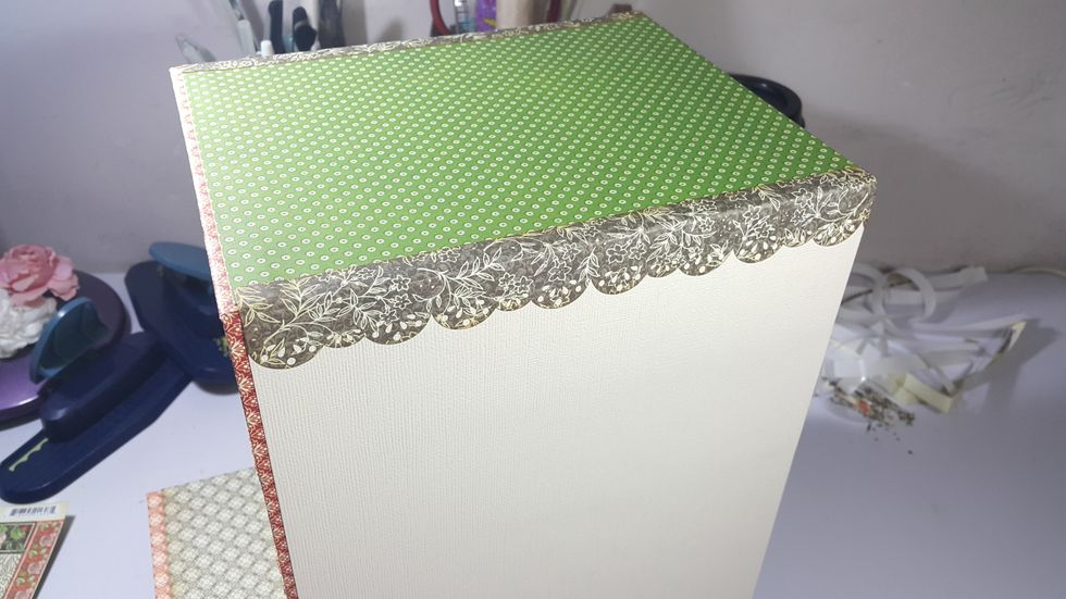 Cover the corners with punched pattern papers of around 1-1/2"x8", or whatever you like to decorate it.