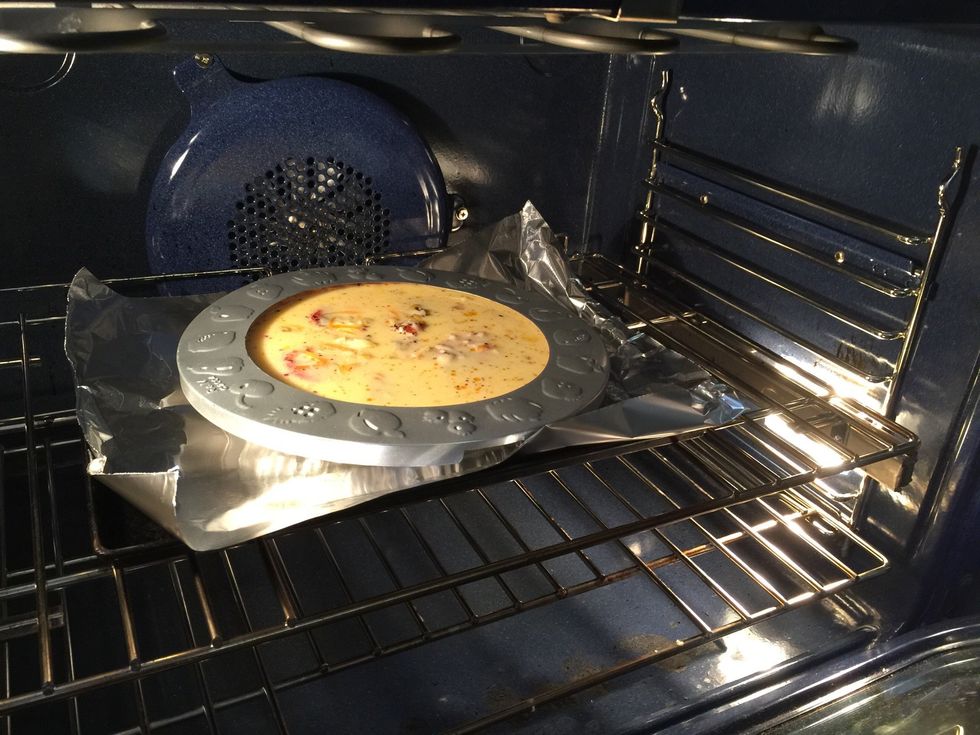 Cover the crust. Remember, it is already baked and you don't want it to burn. Set the timer for about 30 minutes and check it. Think frittata, just set in the center and golden brown.....