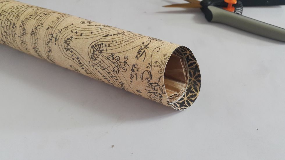 Cover the cylinder with paper of around 6"x9", left 1/2" on both ends and cut the excess