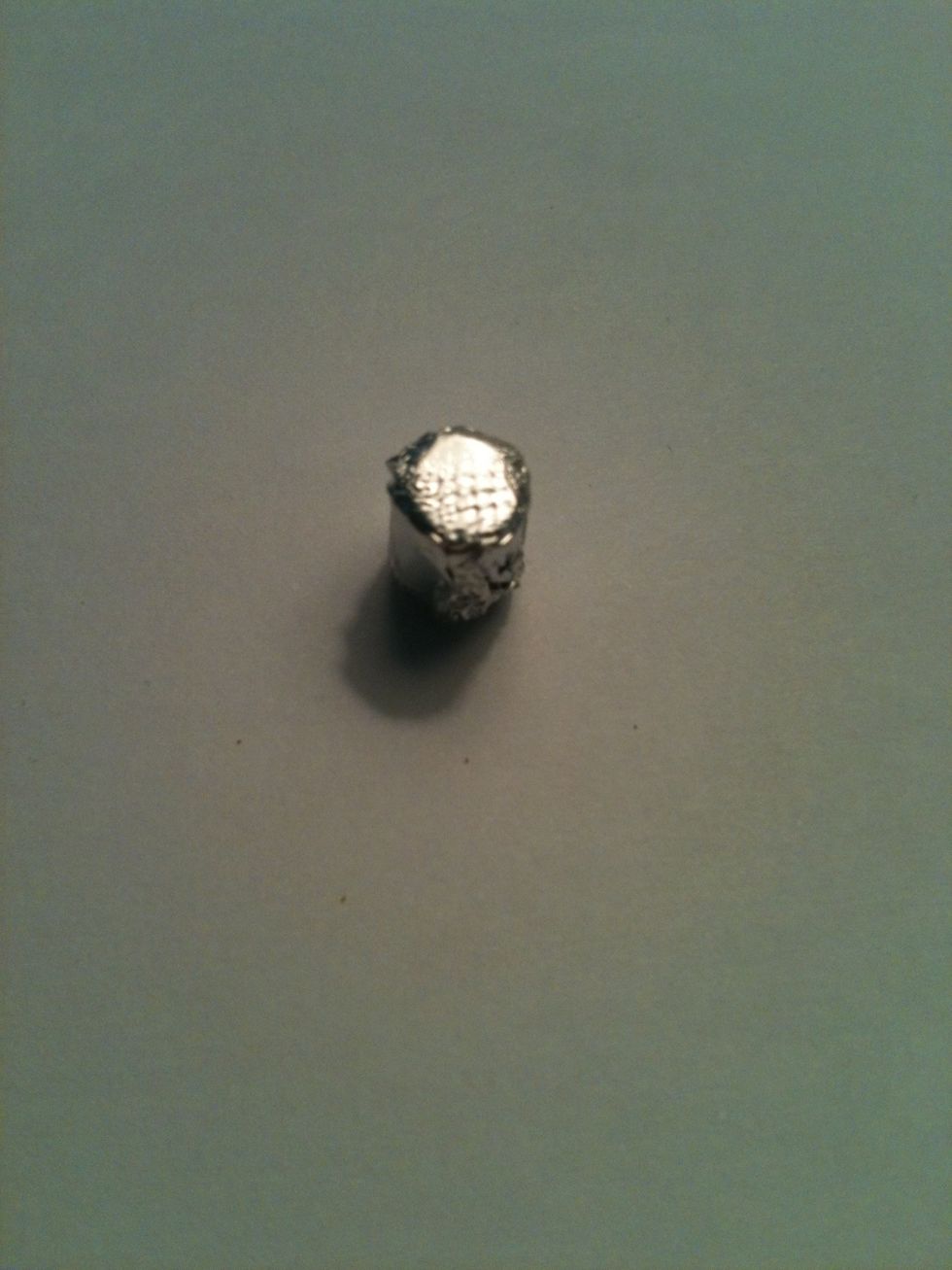 Cover the eraser with aluminum foil. Make sure it's completely enclosed and one end is smoothed out. I smooth it by tapping it on a tabletop.