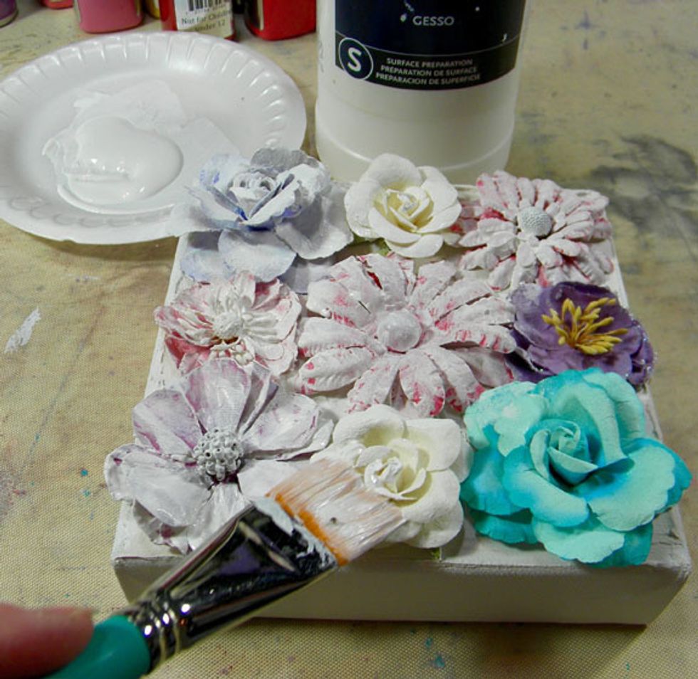 Cover the flowers with fluid gesso.