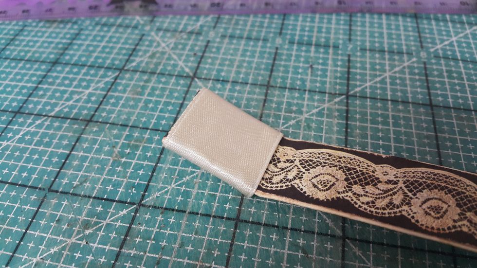 Cover the folded part with ribbons