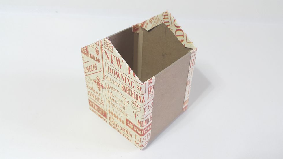 Cover the front and back using papers of 4"(W)x5"(H), trim and fold the excess, left the bottom half inch for connecting.