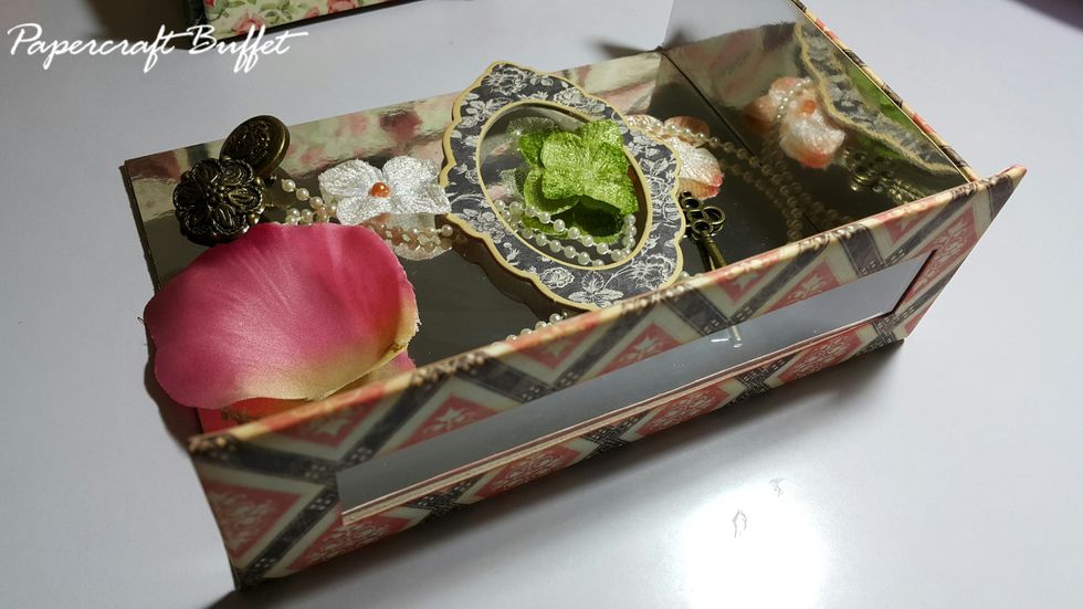 Cover the holes with acetate and then the display drawers with paper and silver cardstock, you can of course use paper instead of cardstock.