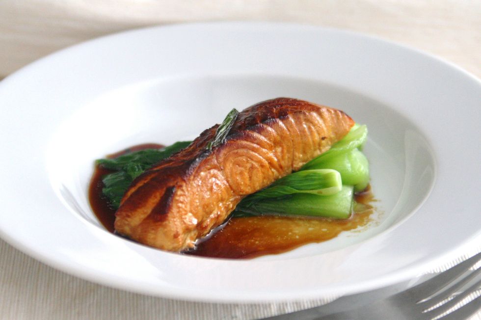 Cover the pan and allow fish to smoke for 8 to 10 minutes, without turning, until the fish is just cooked through. Salmon should be brownish pink and medium rare. Serve with ginger scallion sauce.