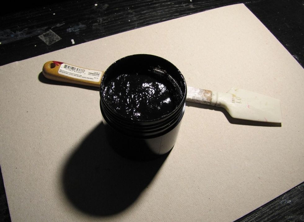 Cover the paper with black gesso. One or two layers.