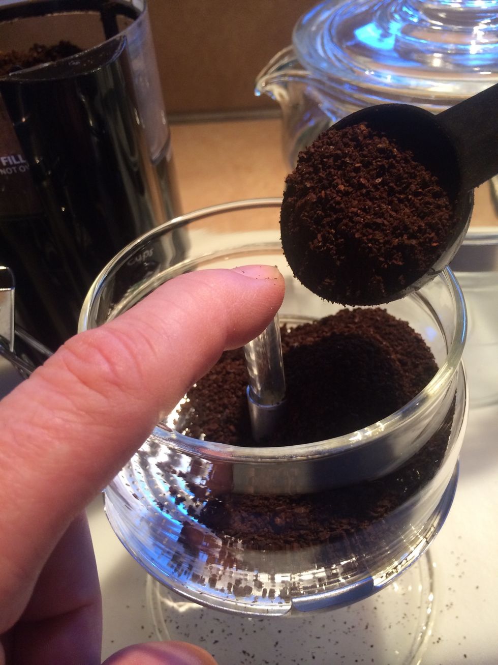 Cover the perk tube to put the coffee into the brew basket. This pot, 6 cups, 6 scoops.