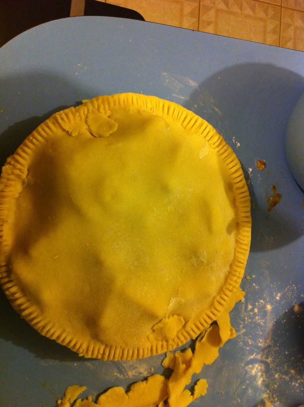 Cover the pie and press down the edges either pinching or with a fork. Patch up any holes with excess pastry.