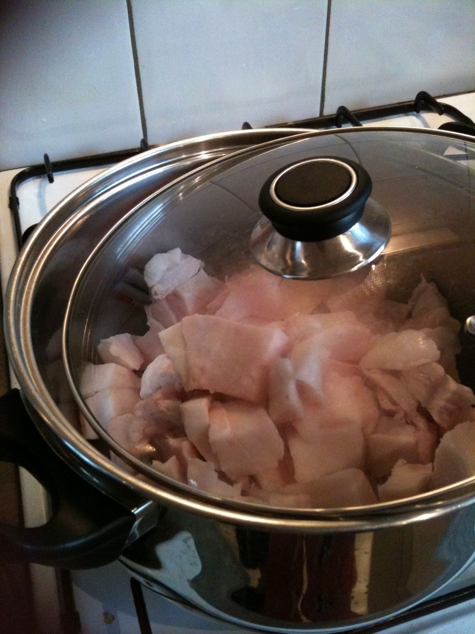 Cover the pot slightly and wait until the fat begins to render into liquid, occasionally stirring with a wooden spoon.