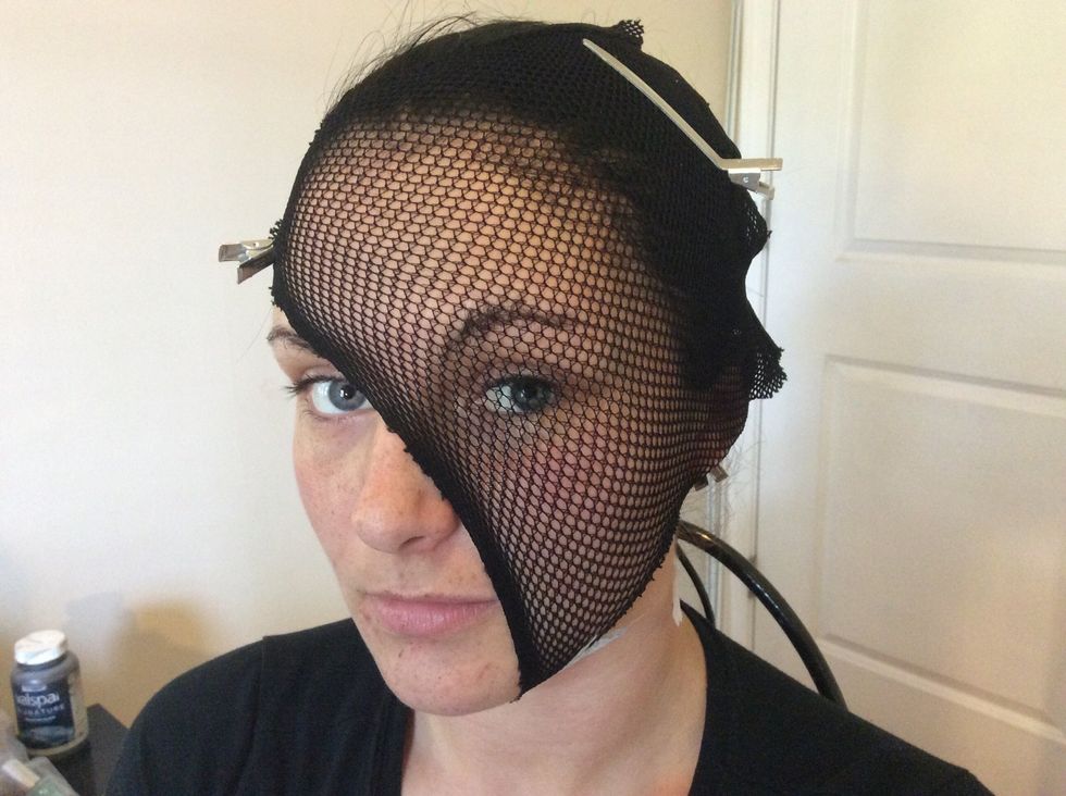 Cover the section of your face that you want to look like scales with the fish net hose