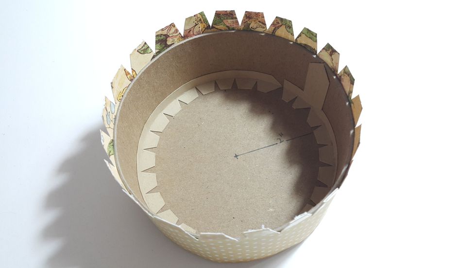 Cover the sides with paper of 2" width, left half inch for adhere onto the box as shown