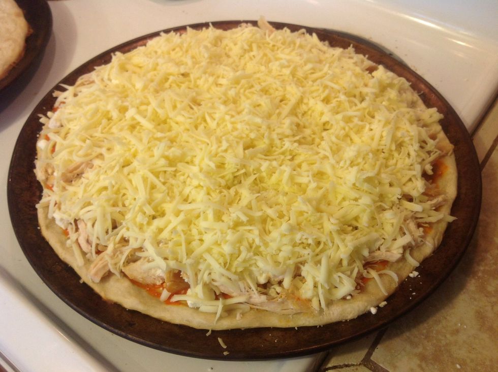 Cover the toppings with a layer of shredded Monterey Jack cheese.