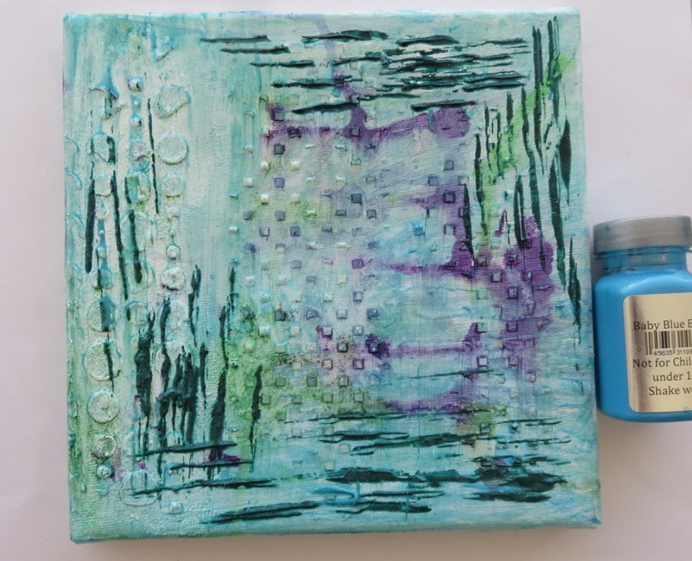 Cover the whole canvas with a very thin layer of Baby Blue Eyes Sorbet paint. I used a dry baby wipe and my finger to cover the surface with a thin layer of paint.